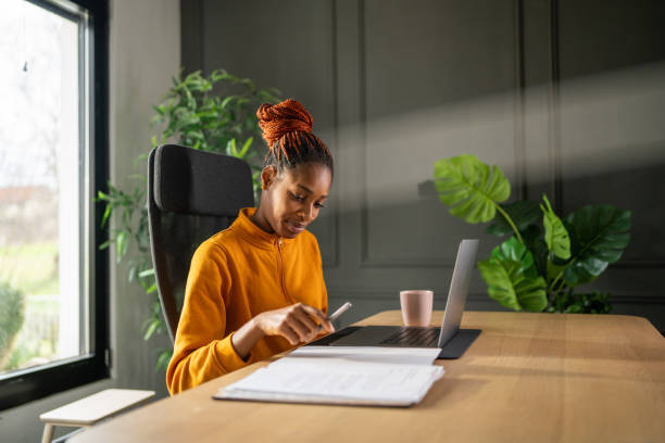 istock Female student taking notes at online class lesson on laptop 2158958563
