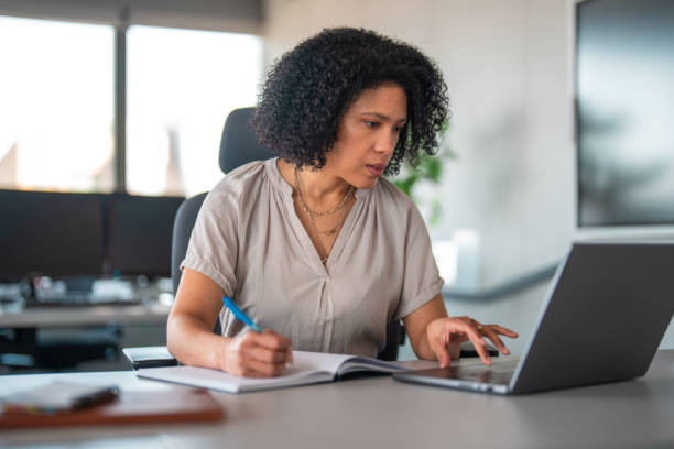 istock Hispanic Businesswoman Engaged in Office Work 2158960256