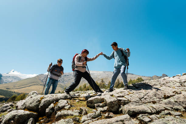 istock Young man helping friend during a trail on a Laguna Radian, Peru 2158961533