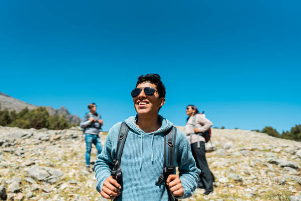 istock Young man walking and looking around on trail on a Laguna Radian, Peru 2158963447