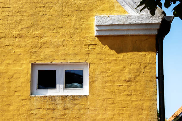 istock white window in a yellow painted house 2158963501