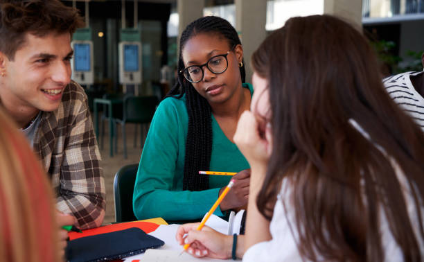 istock Group of university students gathered in the campus bar, studying together. 2158963647
