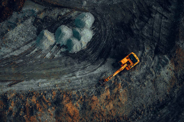 istock Excavator at work on a dark background. Top view from a drone 2158964196