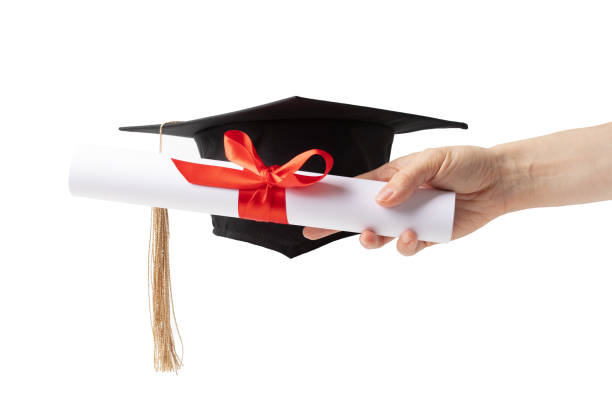 istock Graduation cap and diploma in hand on white background, education ceremony, graduate student, learning journey 2158964764