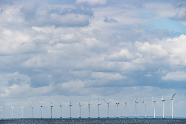 Row of wind turbines at sea on an overcast day. Shot near Copenhagen, Denmark.