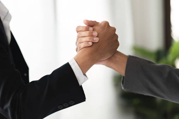 istock Businessmen Shaking Hands in Agreement, Symbolizing Partnership and Collaboration in a Modern Office Setting 2158966797