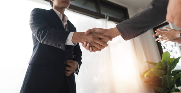 istock Businessmen Shaking Hands in Modern Office Setting, Sealing a Deal and Making Agreements Together 2158966830