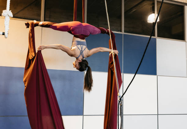 istock Woman performing artistic figure on aerial silks in studio 2158967821