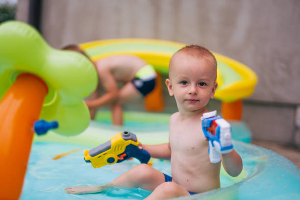 two boys are having fun in the pool