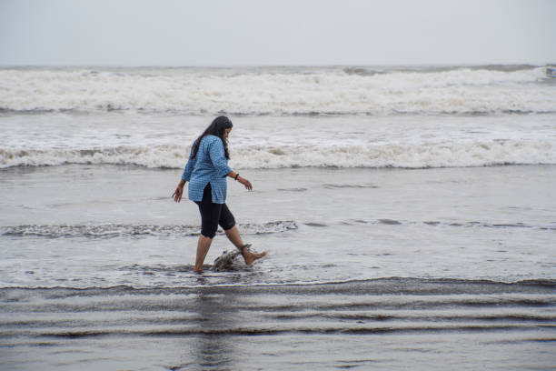 Woman walking and relaxing at sea with copy space. Enjoying breeze. Vacation concept.