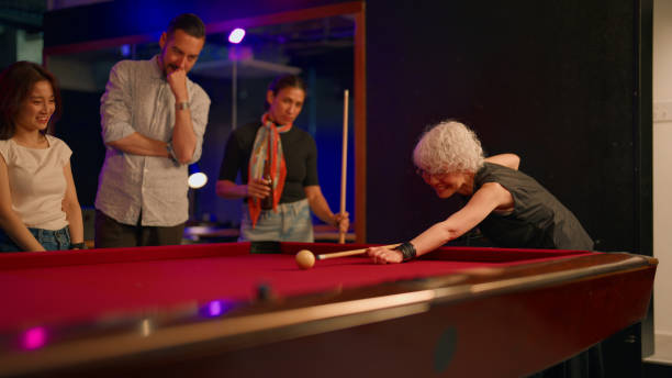 istock Group of multi-ethnic friends playing billiards in pub 2158970038