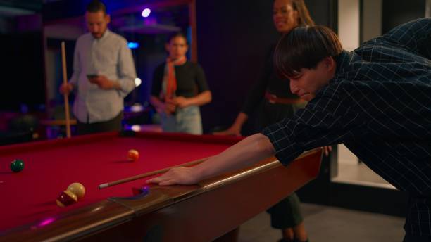 istock Group of multi-ethnic friends playing billiards in pub 2158970083
