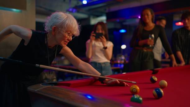 istock Group of multi-ethnic friends playing billiards in pub 2158970269