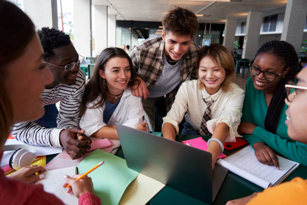 istock Multiracial group of university students sitting in the cafeteria studying together after classes. 2158973218