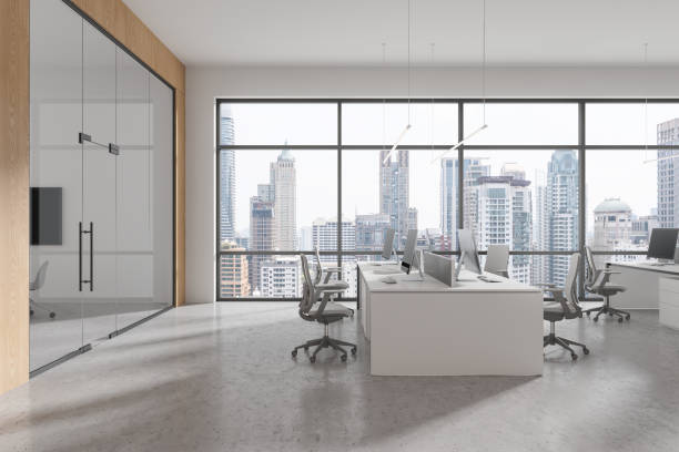 istock Light business room interior with pc computers and chairs near panoramic window 2158973856