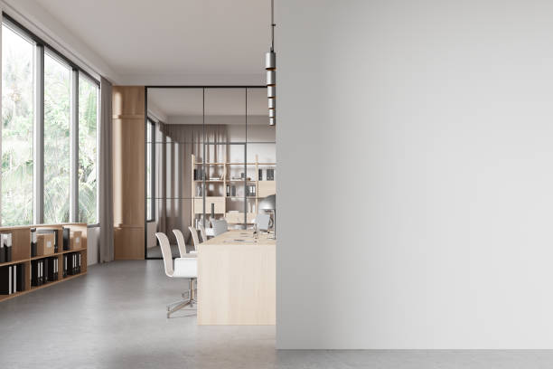 istock Gray and wooden open space office interior with blank wall 2158974121