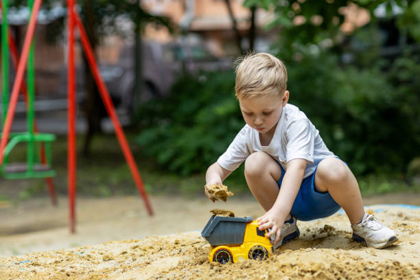 istock A little boy playing in a sandbox in the summertime 2158974528