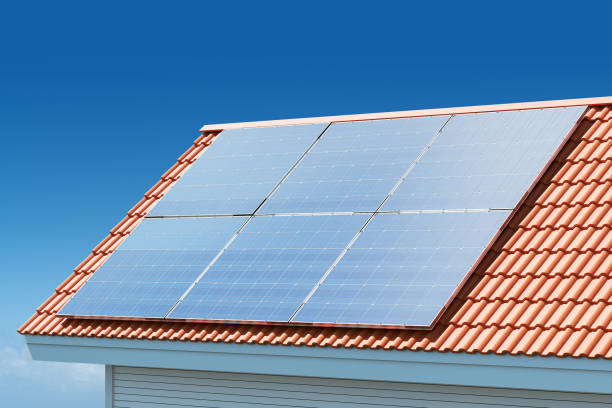 istock House rooftop with solar panels on blue sky background 2158975706