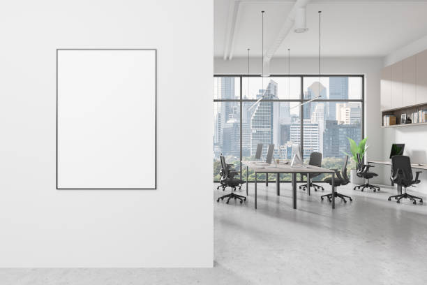 istock A modern office interior with a blank poster on the wall, large windows overlooking Bangkok cityscape, and a workspace setup, 3D Rendering 2158975813
