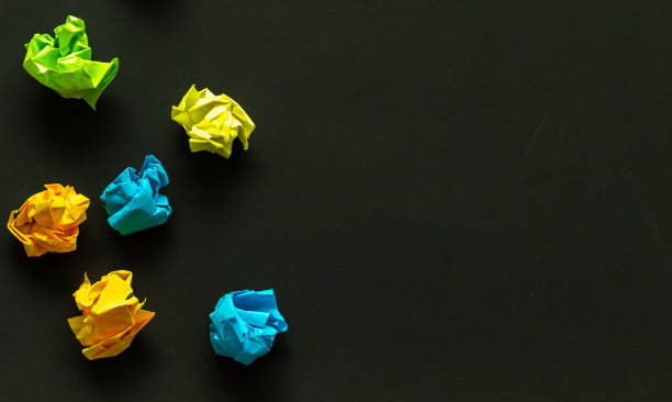 istock rumpled sheets of colored paper on a dark background, failed attempts, motivation concept 2158976961