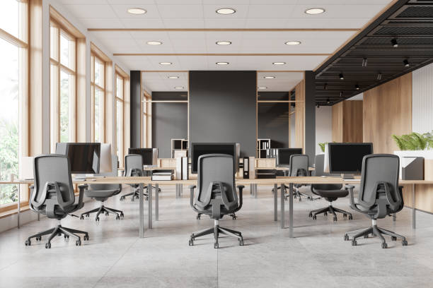 istock Modern office space with desks and chairs, natural light from windows, gray and wooden design. Concept of workplace. 3D Rendering 2158977146