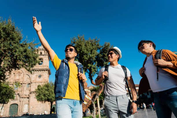 Male traveler friends looking at view on Cusco, Peru
