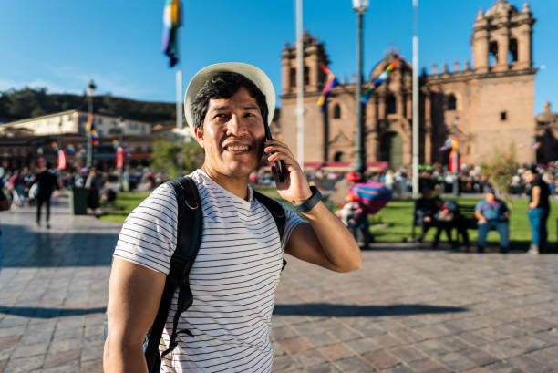 istock Mid adult traveler man talking on phone on Cusco, Peru 2158977501