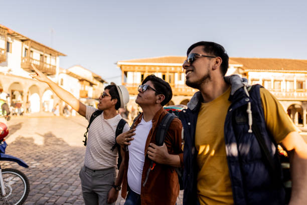 Male traveler friends looking at view on Cusco, Peru
