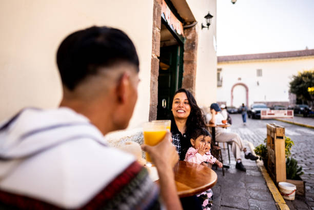 Couple toasting with their baby daughter at outdoors restaurant