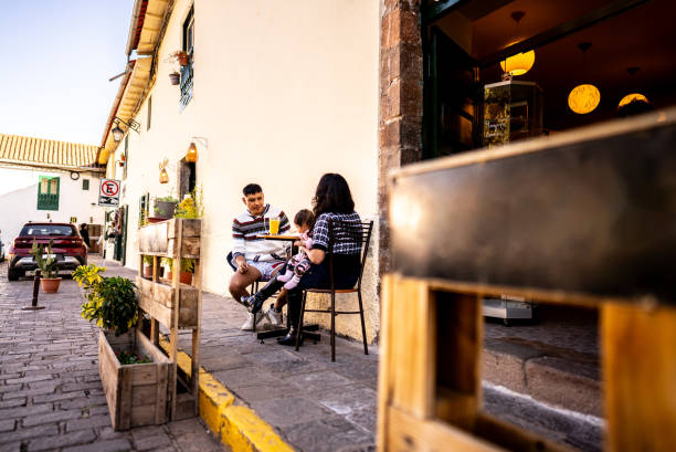 Couple with their baby daughter at outdoors restaurant