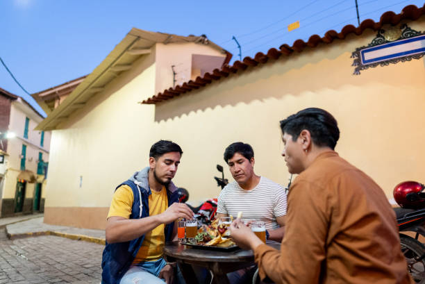 istock Male traveler friends eating on outdoors restaurant in Cusco, Peru 2158977782