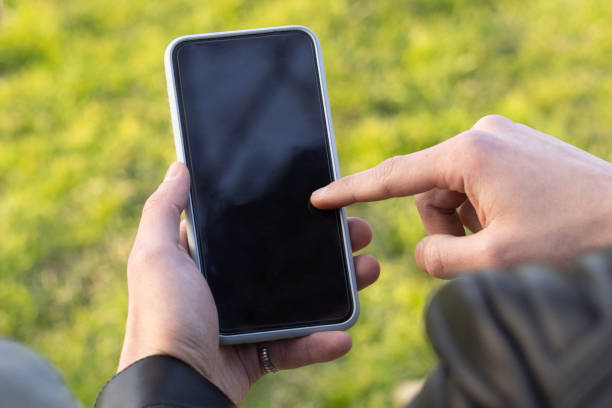 istock man's hand playing with his phone 2158977900