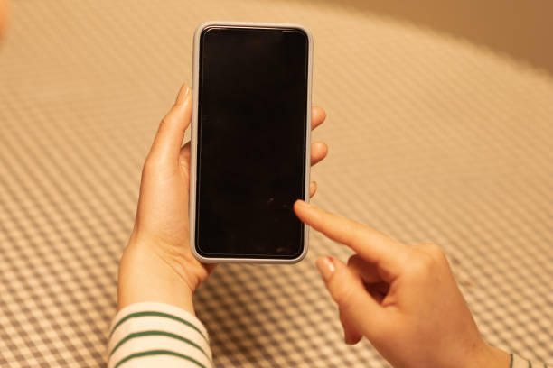 istock Woman's hand playing with his phone 2158977902