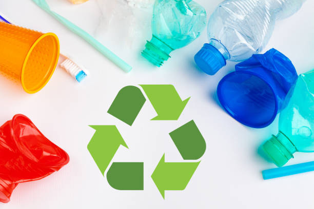 istock waste recycling eco symbol with garbage disposal on table background top 2158978575