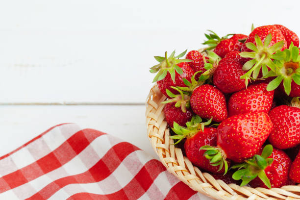 Red ripe strawberries in a basket on a beautiful background