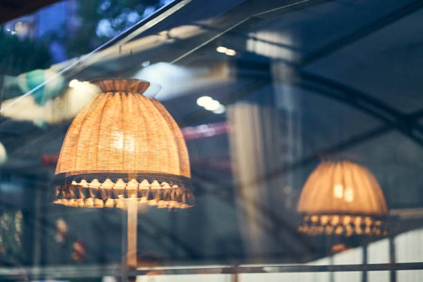 istock Vintage floor lamp with yellow light is reflected in a dark window with space to copy 2158980579