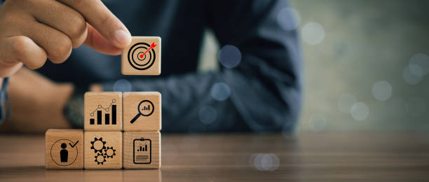 istock business strategy, Action plan, Goal and target, hand stack woods block step on table with icon about business strategy and Action plan. business development concept. copy space. 2158981196