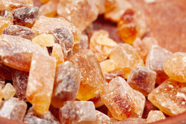 istock brown sugar rock organic crystalline close up on dark background 2158981377