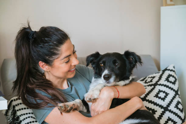 istock Woman hugging  her adopted dog at home 2158982278