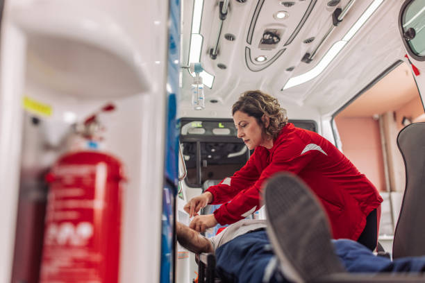 istock Female paramedic assisting injured patient inside ambulance 2158984673