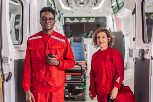 istock Two paramedics smiling inside ambulance with medical equipment 2158984852
