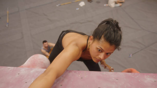 Woman climbing in indoor climbing gym