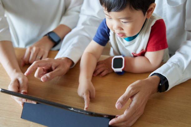 istock Children and parents play with computers and smartwatches 2158989311