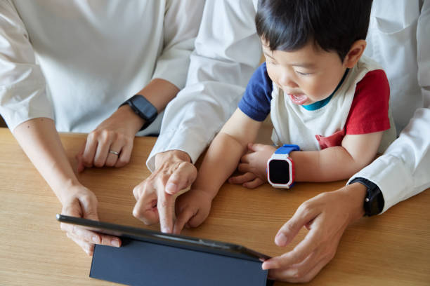 istock Children and parents play with computers and smartwatches 2158989315