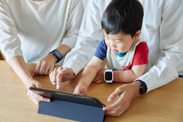 istock Children and parents play with computers and smartwatches 2158989340