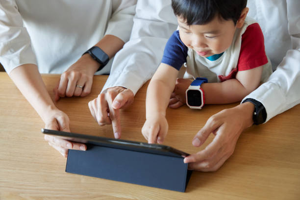 istock Children and parents play with computers and smartwatches 2158989343