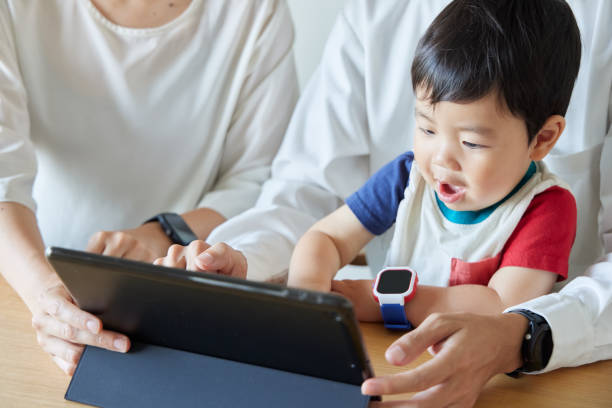 istock Children and parents play with computers and smartwatches 2158989352