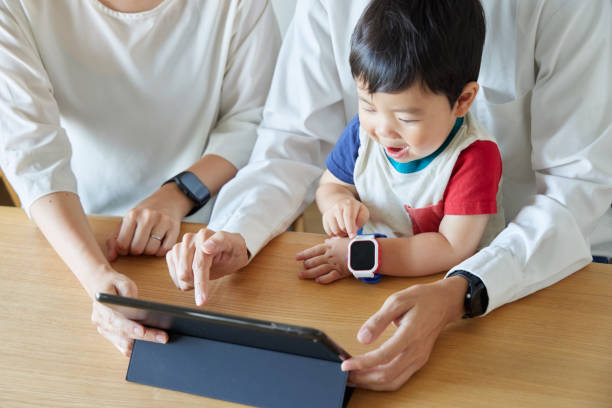 Children and parents play with computers and smartwatches