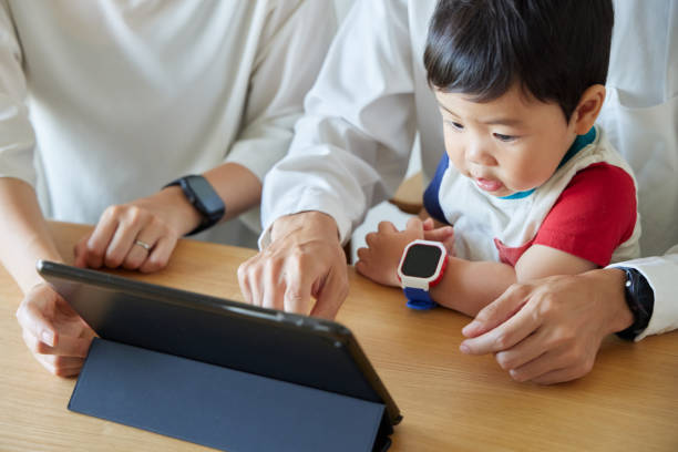 istock Children and parents play with computers and smartwatches 2158989393