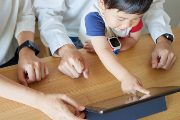 istock Children and parents play with computers and smartwatches 2158989408